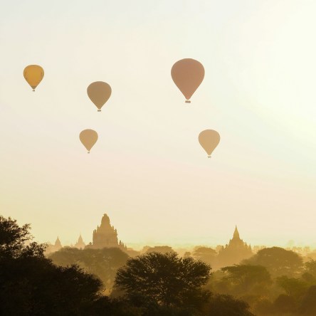 Sunrise in Bagan, Myanmar with hot air balloons in the sky