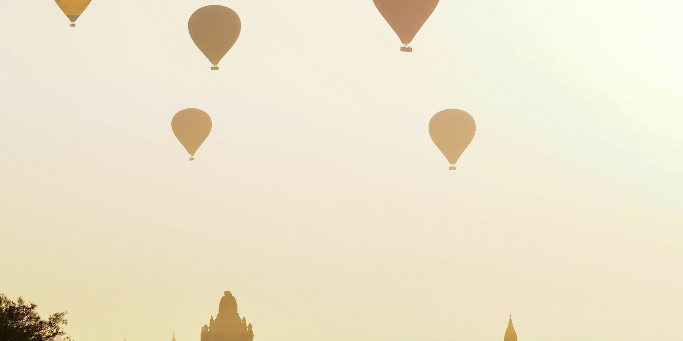 Sunrise in Bagan, Myanmar with hot air balloons in the sky