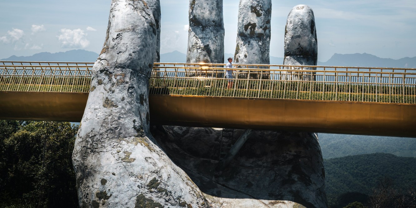 Footbridge over a giant stone hand in Vietnam
